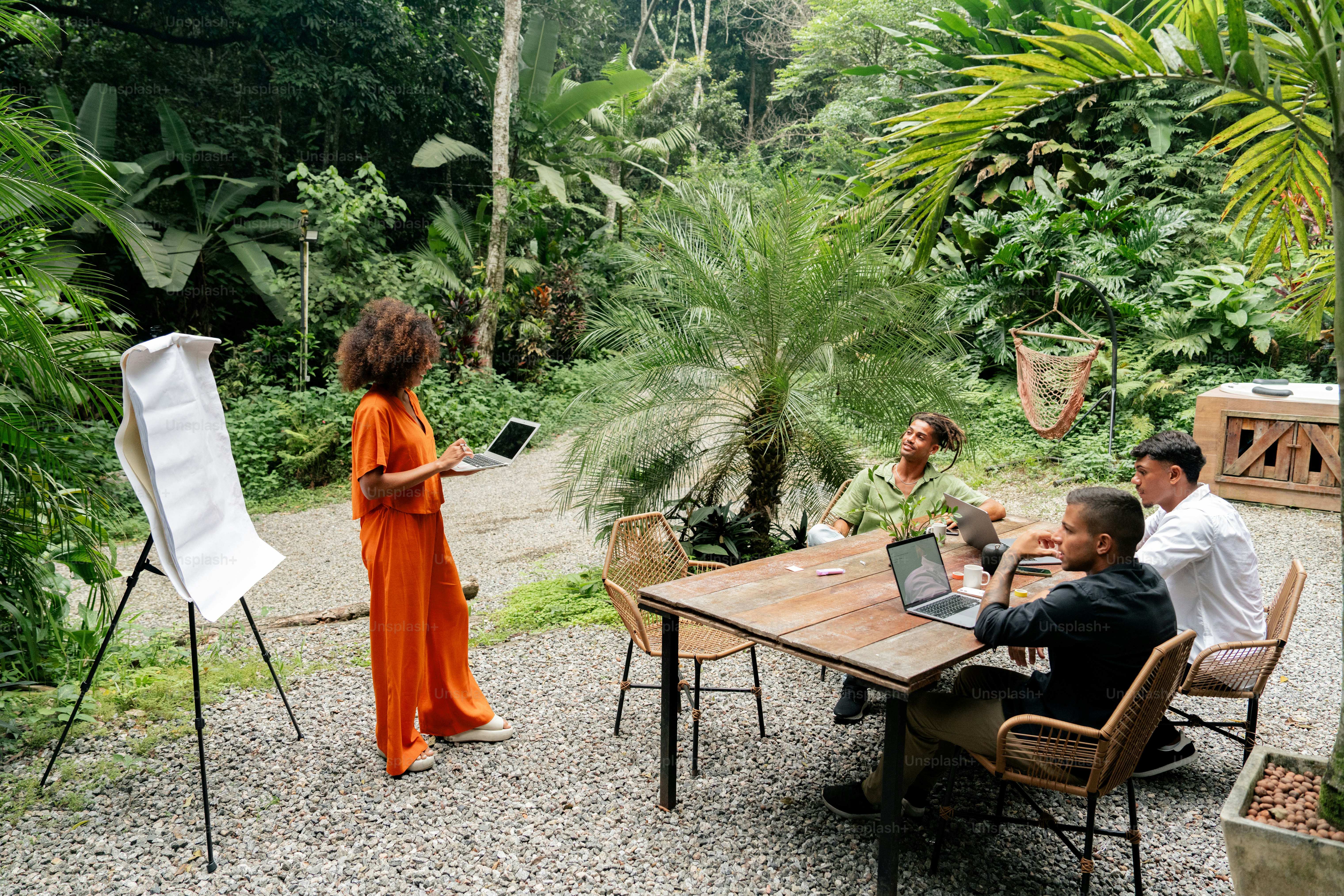 a group of people sitting around a wooden table