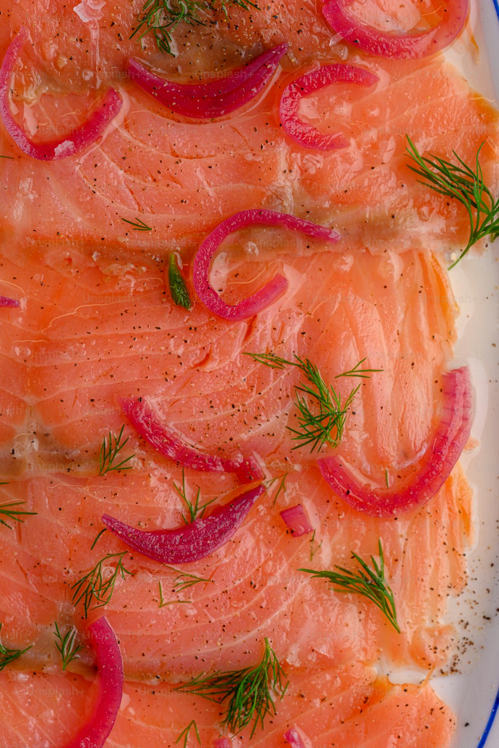 a white plate topped with salmon and onions