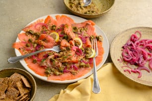 a plate of food on a table next to bowls of food