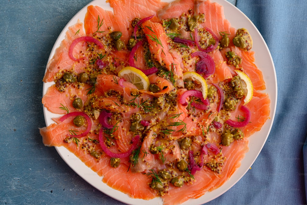 a white plate topped with lots of fish