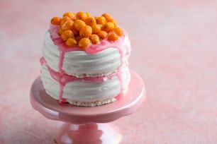 a pink and white cake on a pink plate