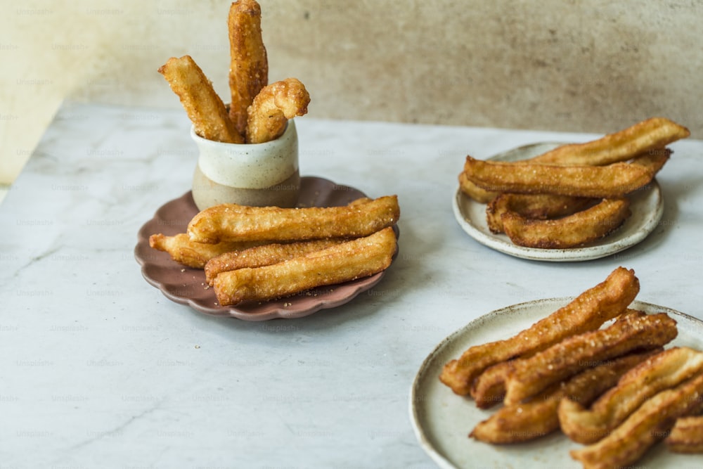 a table topped with plates filled with french fries