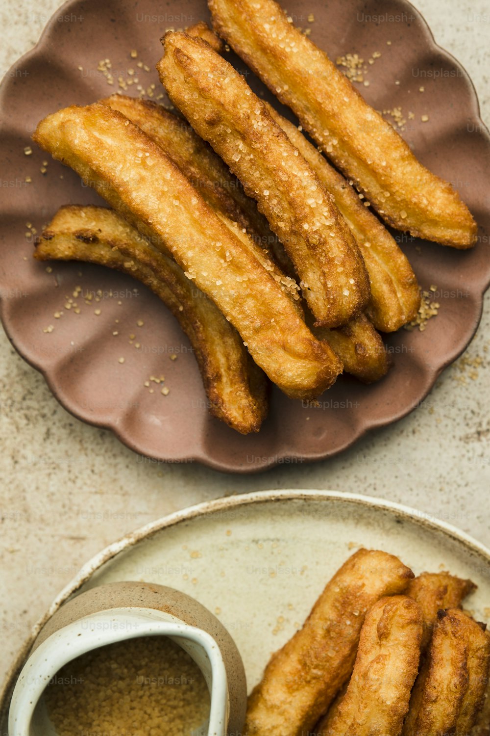 a plate of fried food next to a bowl of dipping sauce