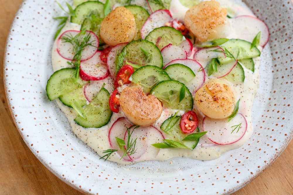 a white plate topped with cucumbers and radishes