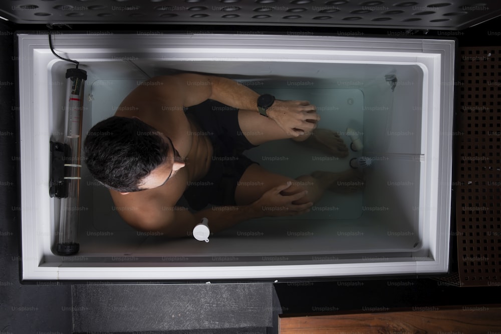 a man in a black swimsuit in a microwave