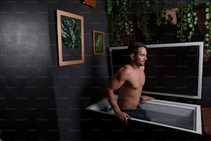 a man standing in a bathtub in a bathroom