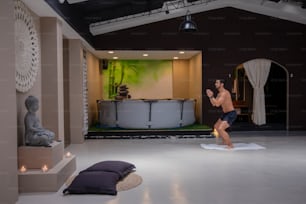 a man standing on a mat in a room