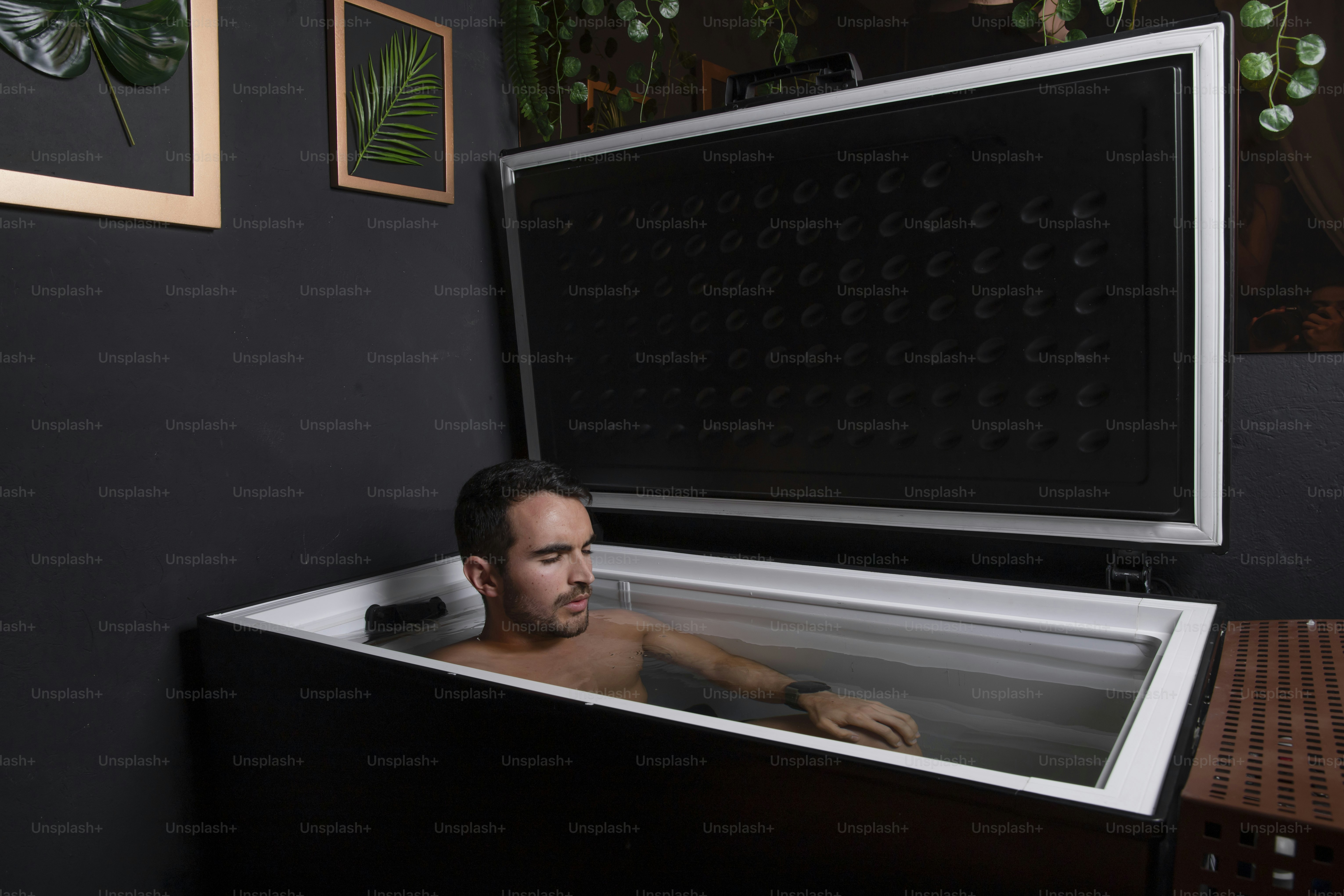 a man sitting in a bathtub in a room