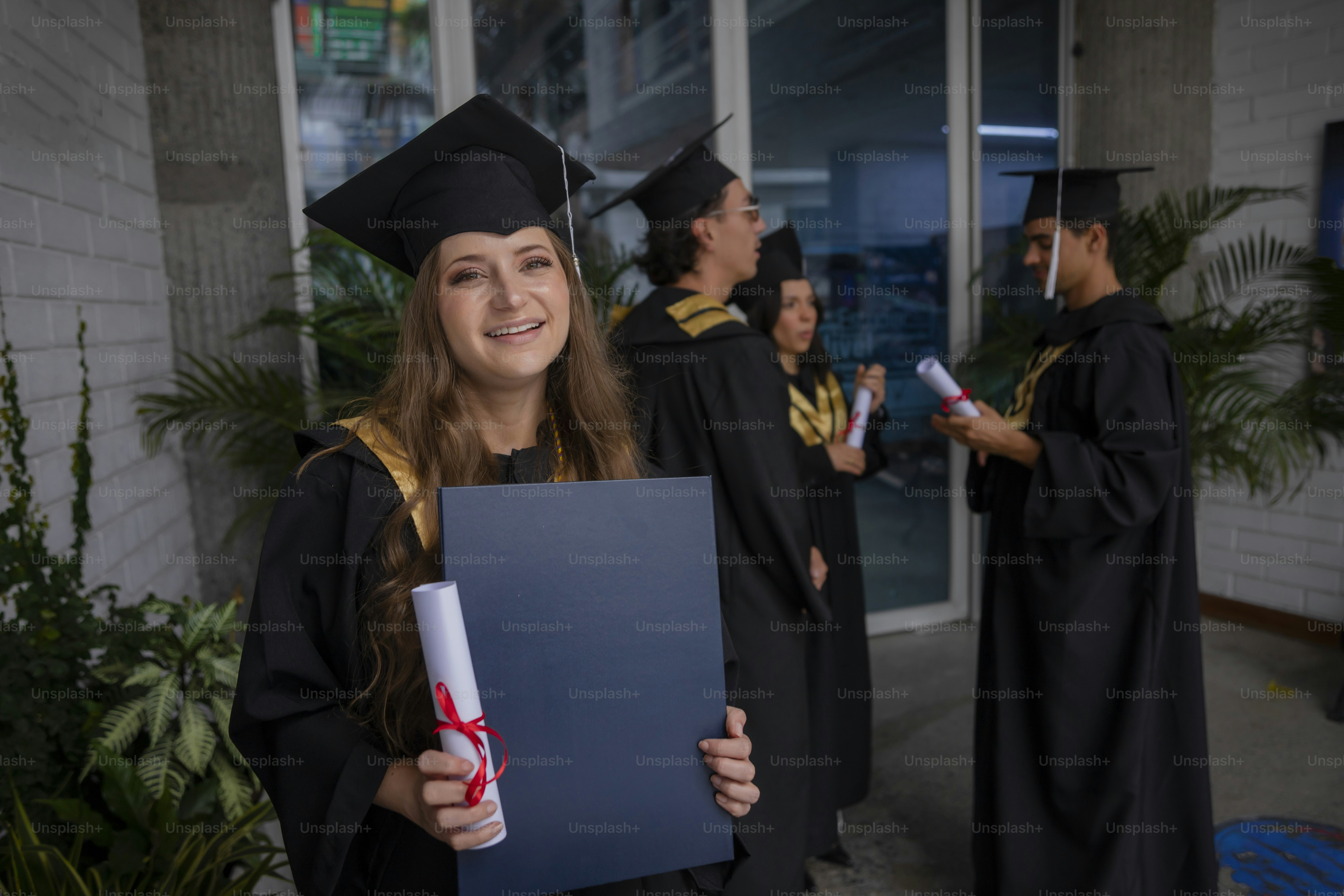 a woman in a graduation gown holding a diploma