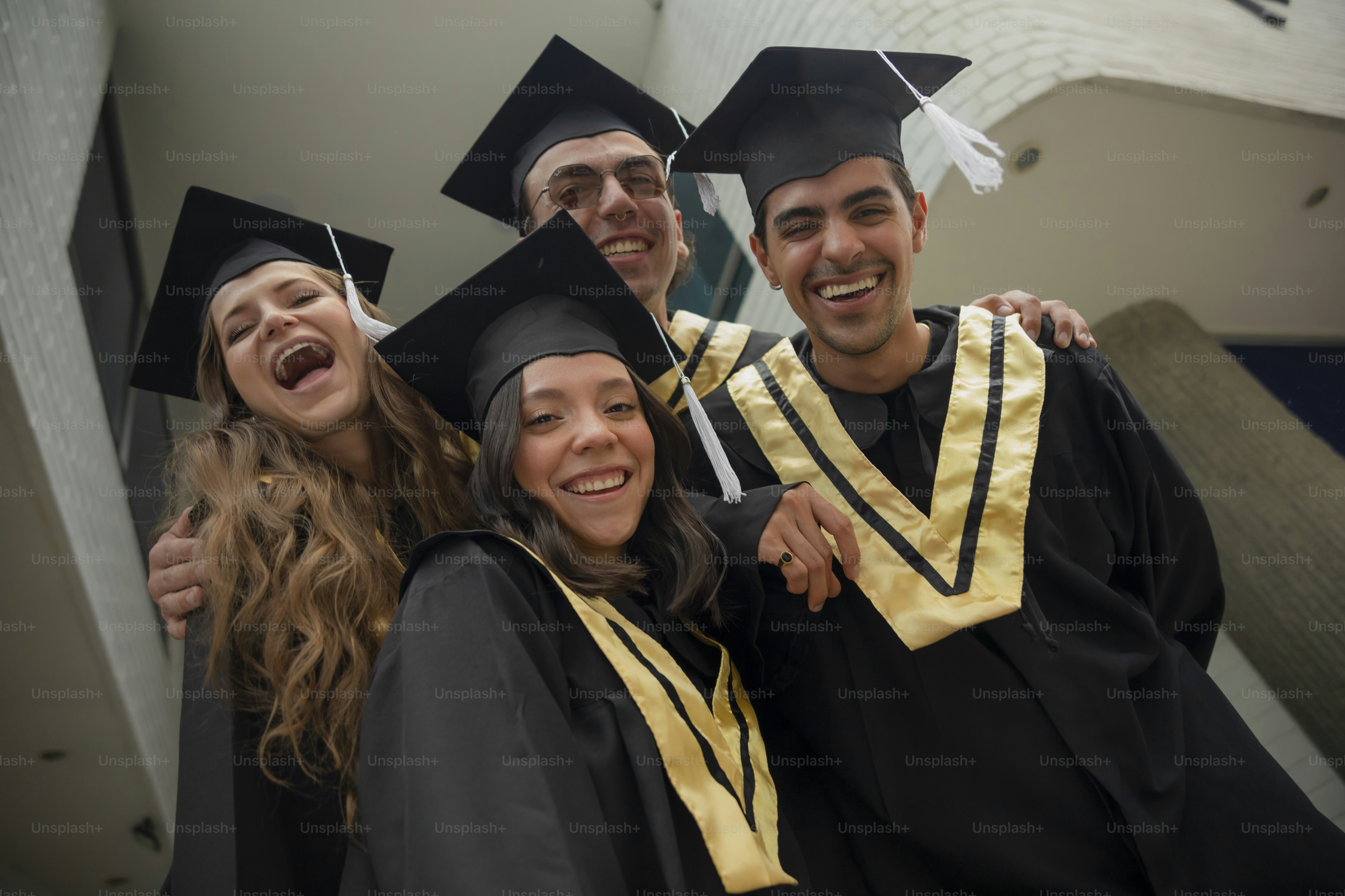 a group of people in graduation gowns posing for a picture