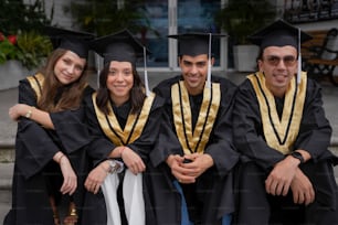 a group of people in graduation gowns posing for a picture