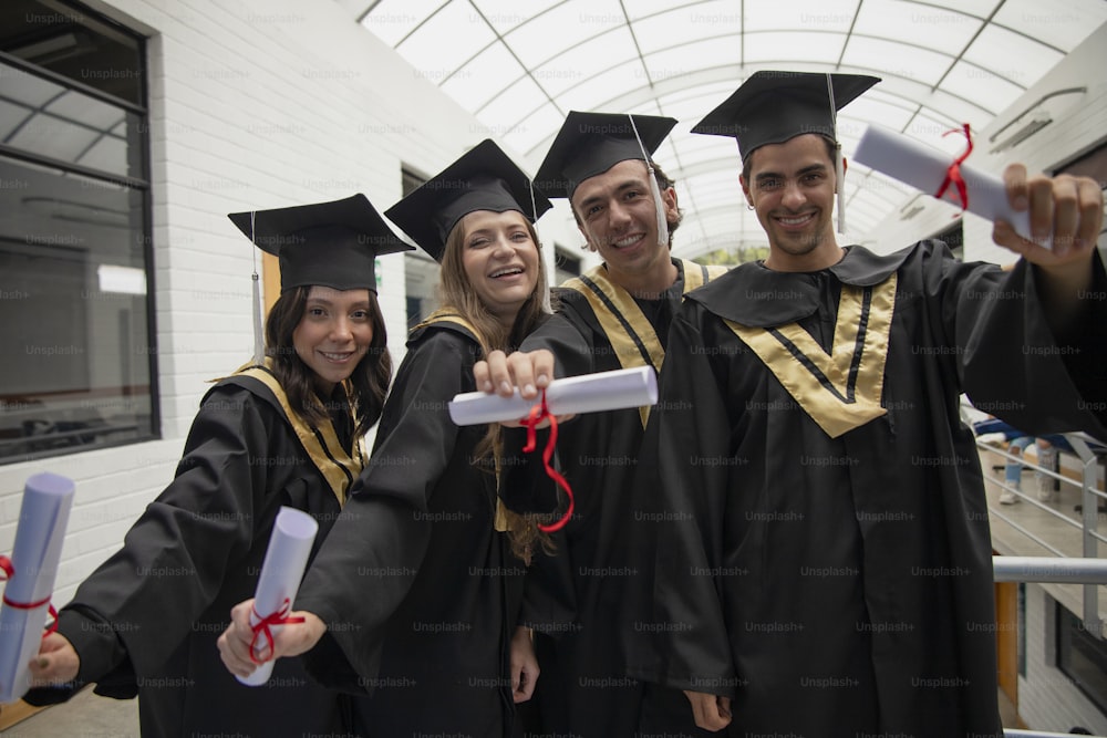 a group of people in graduation gowns posing for a picture