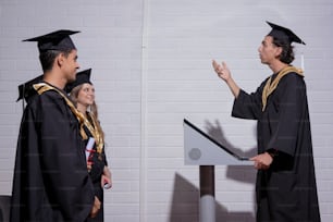 a man giving a speech to a group of graduates