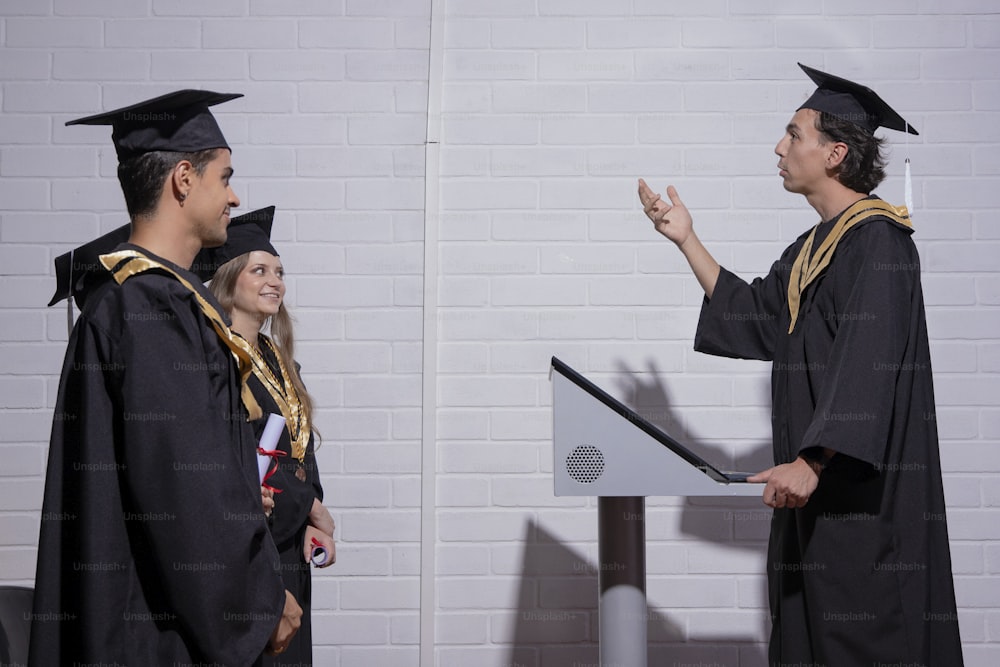 a man giving a speech to a group of graduates