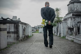 a man in a suit walking down a street