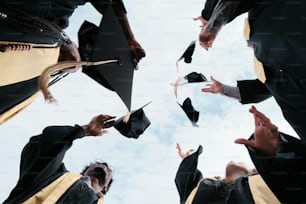 a group of graduates throwing their caps in the air