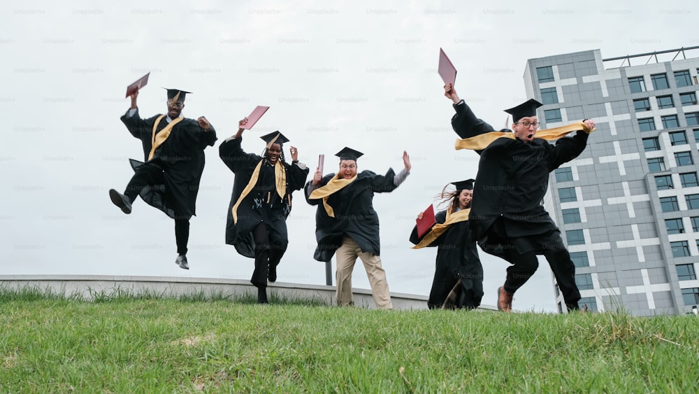 a group of graduates jumping in the air