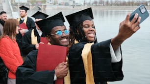 a group of graduates taking a picture with their cell phone