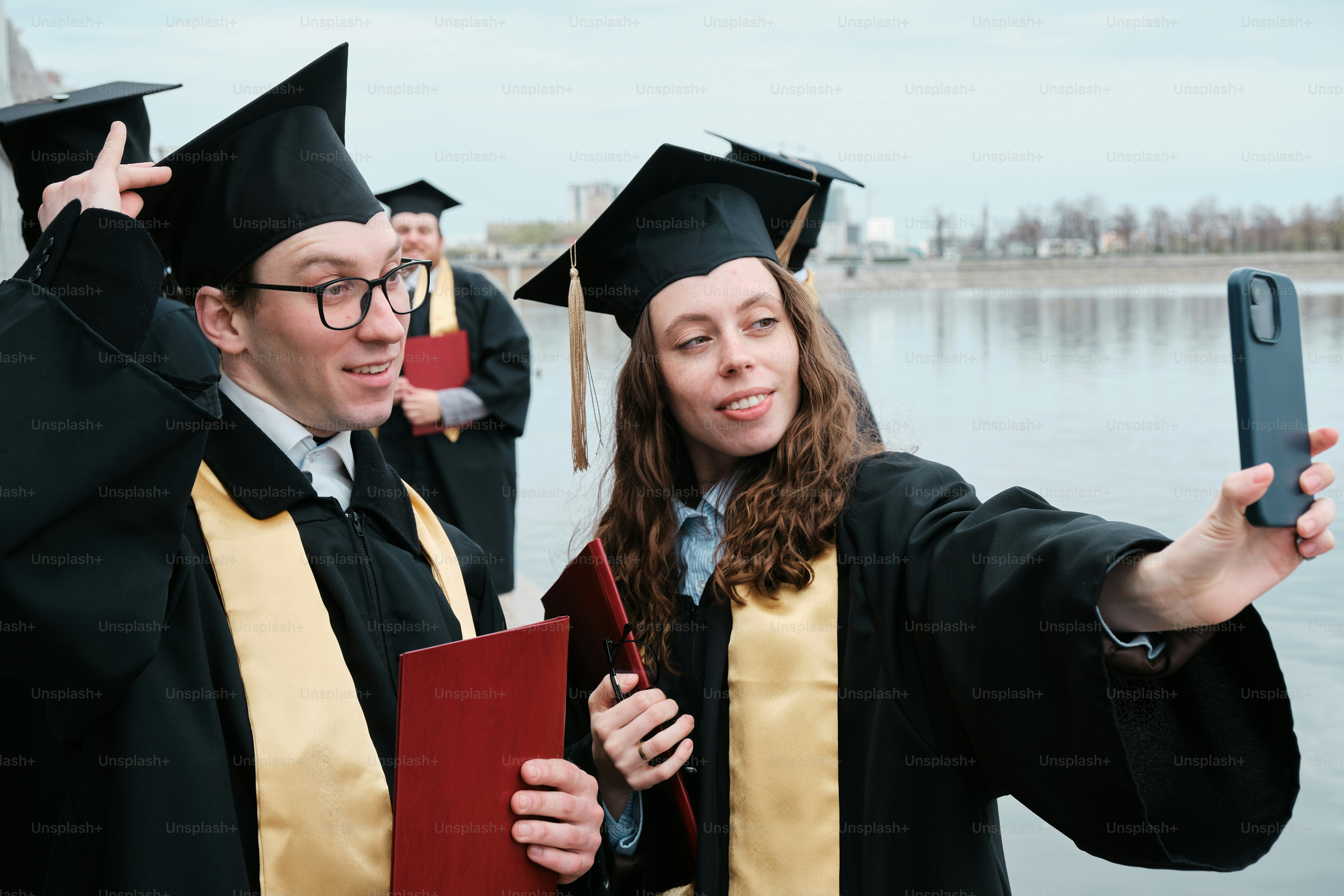 Group of friends taking a selfie in their graduation gown