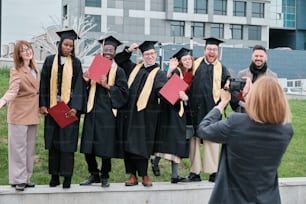 a group of people in graduation gowns posing for a picture