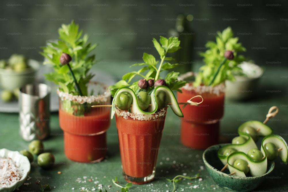 a table topped with three small cups filled with food