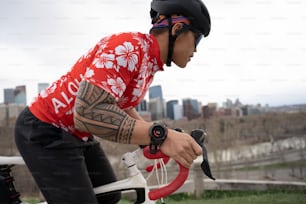 a man with a tattoo on his arm riding a bike