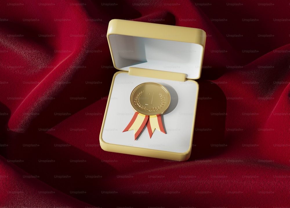 a gold medal sitting on top of a red cloth