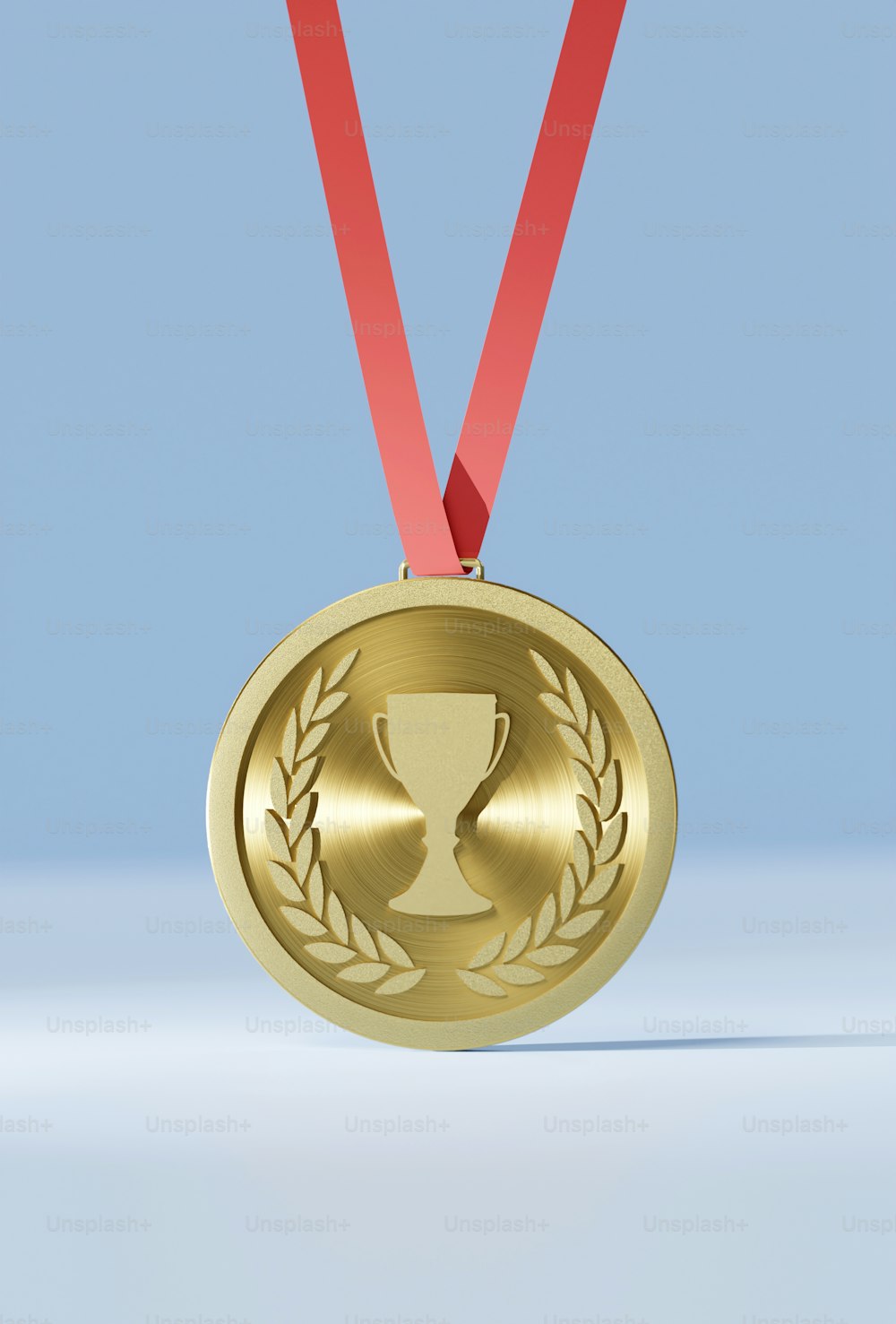 a gold medal with a red ribbon around it