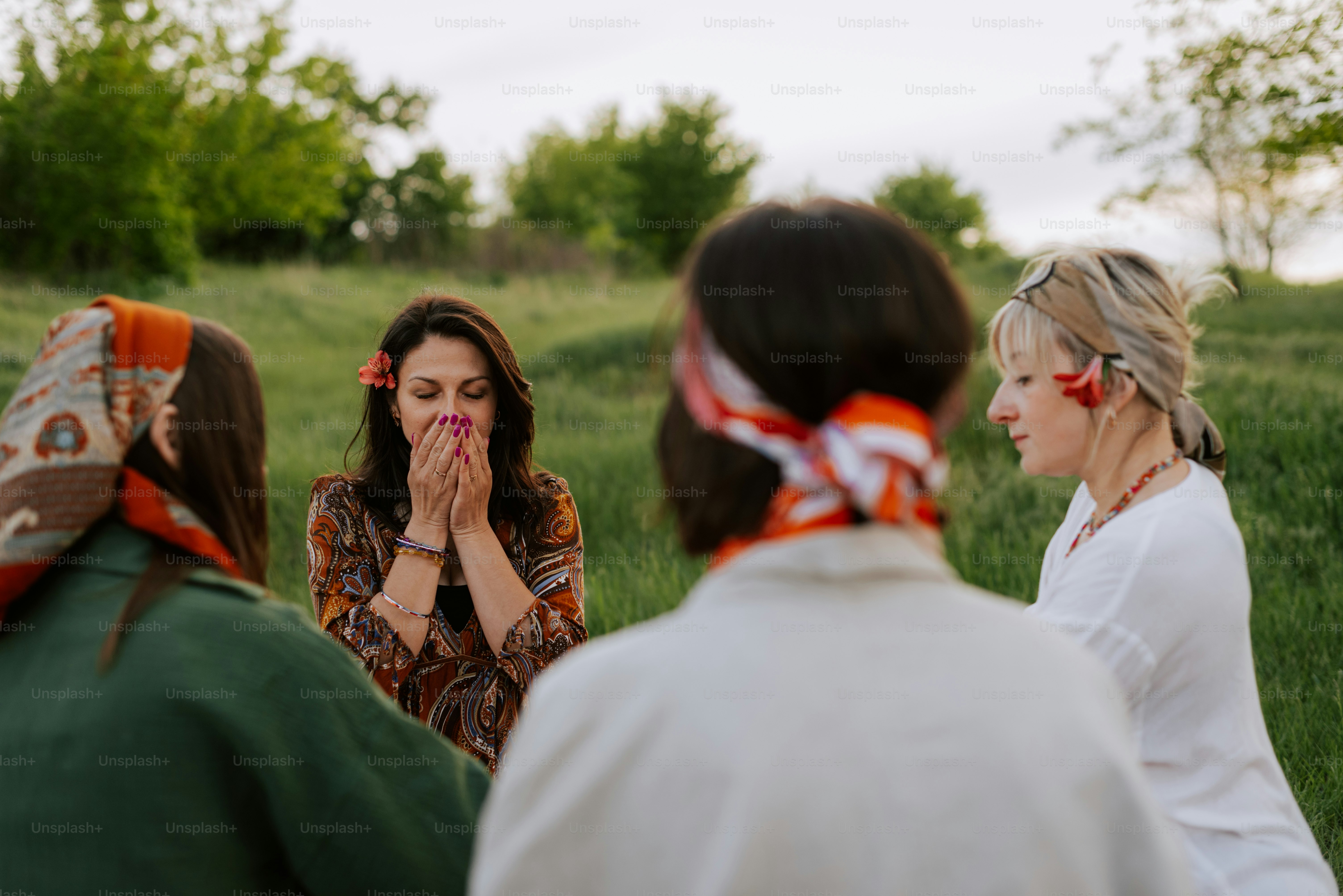A group of women standing around each other in a field photo – Health ...