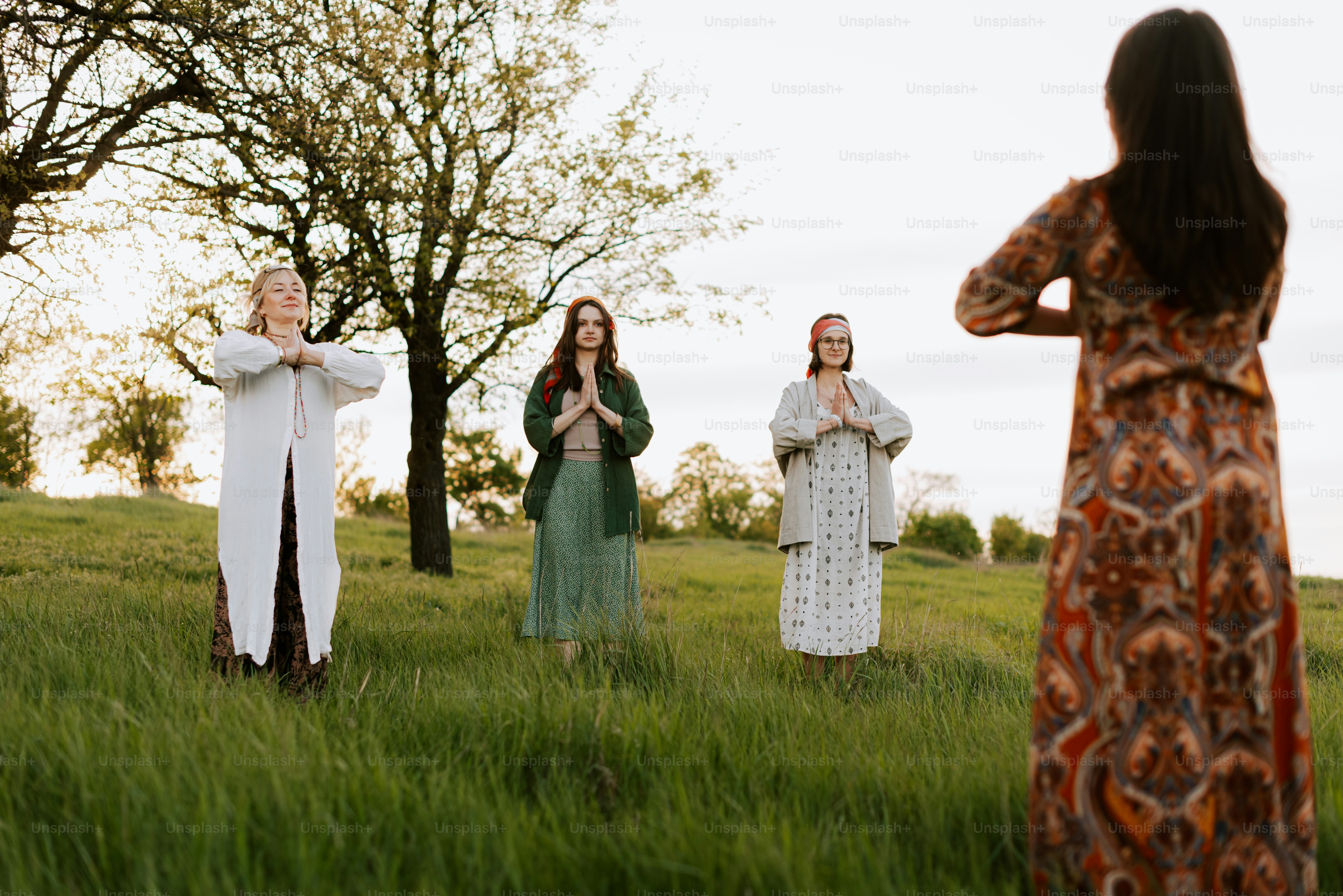 a group of women standing on top of a lush green field