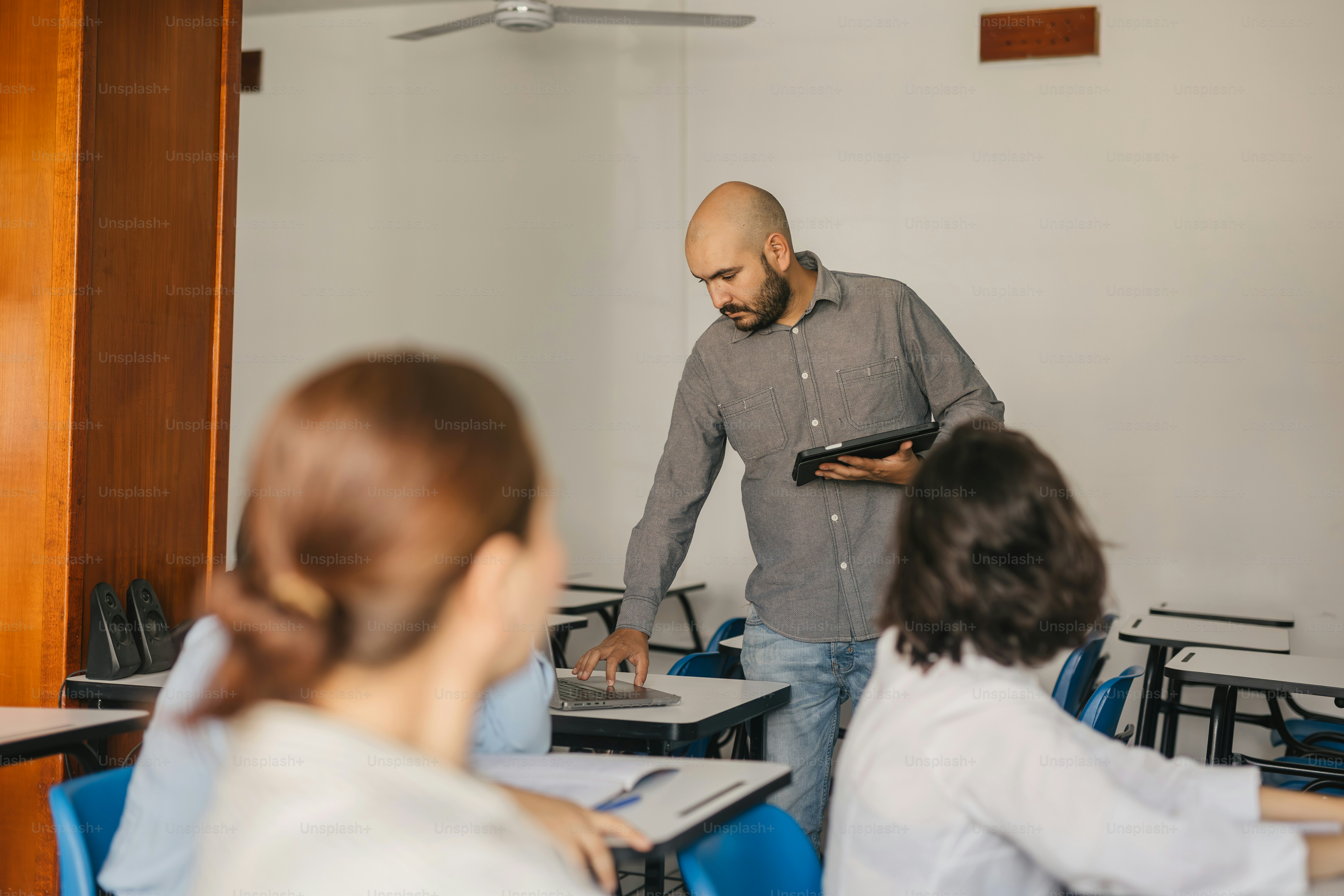 a man standing in front of a classroom full of students