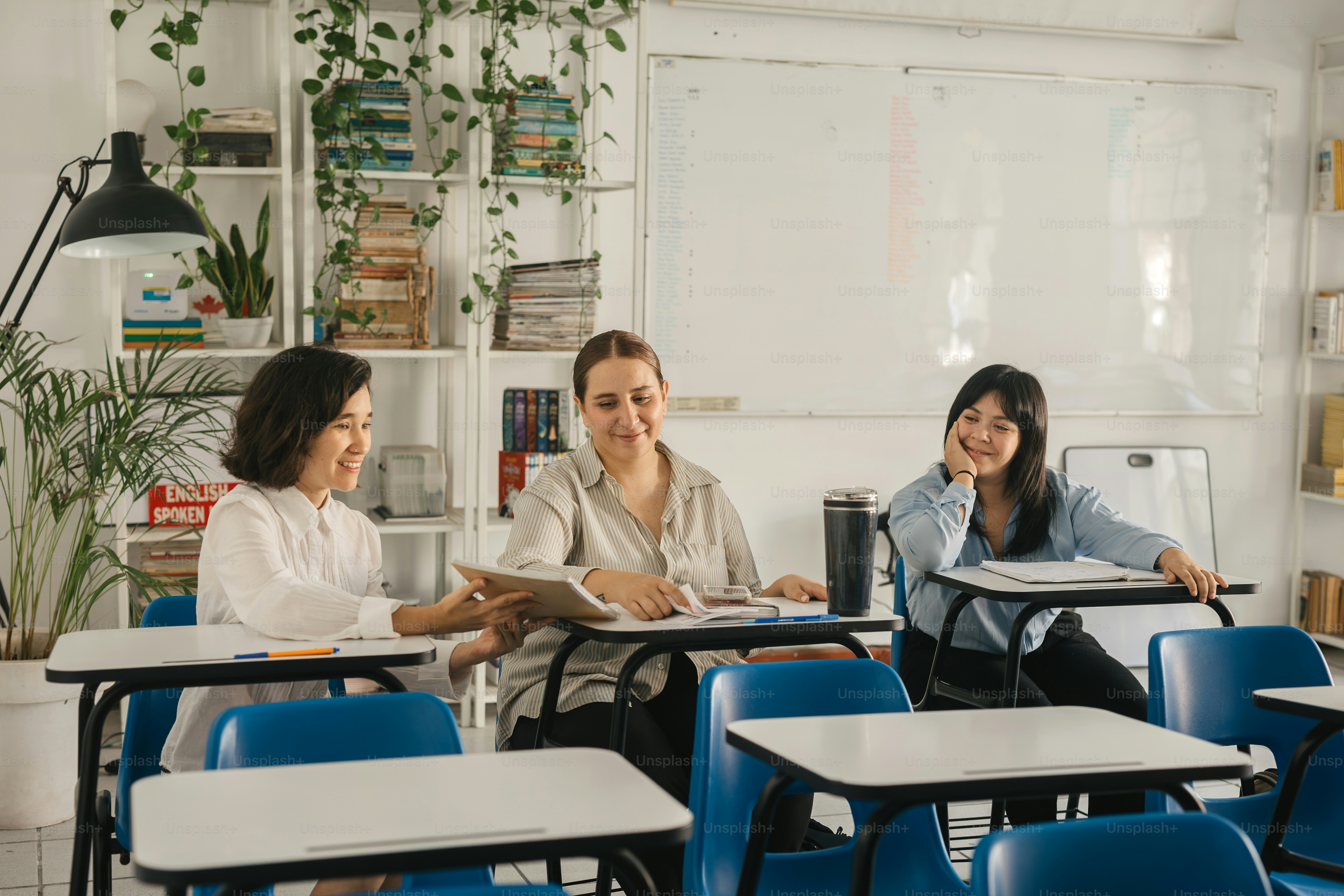 un grupo de mujeres sentadas en pupitres en un aula