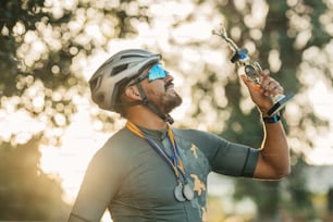 a man wearing a helmet and holding a bike handle