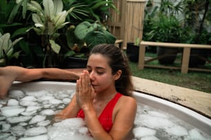 a woman in a hot tub with a man in the background