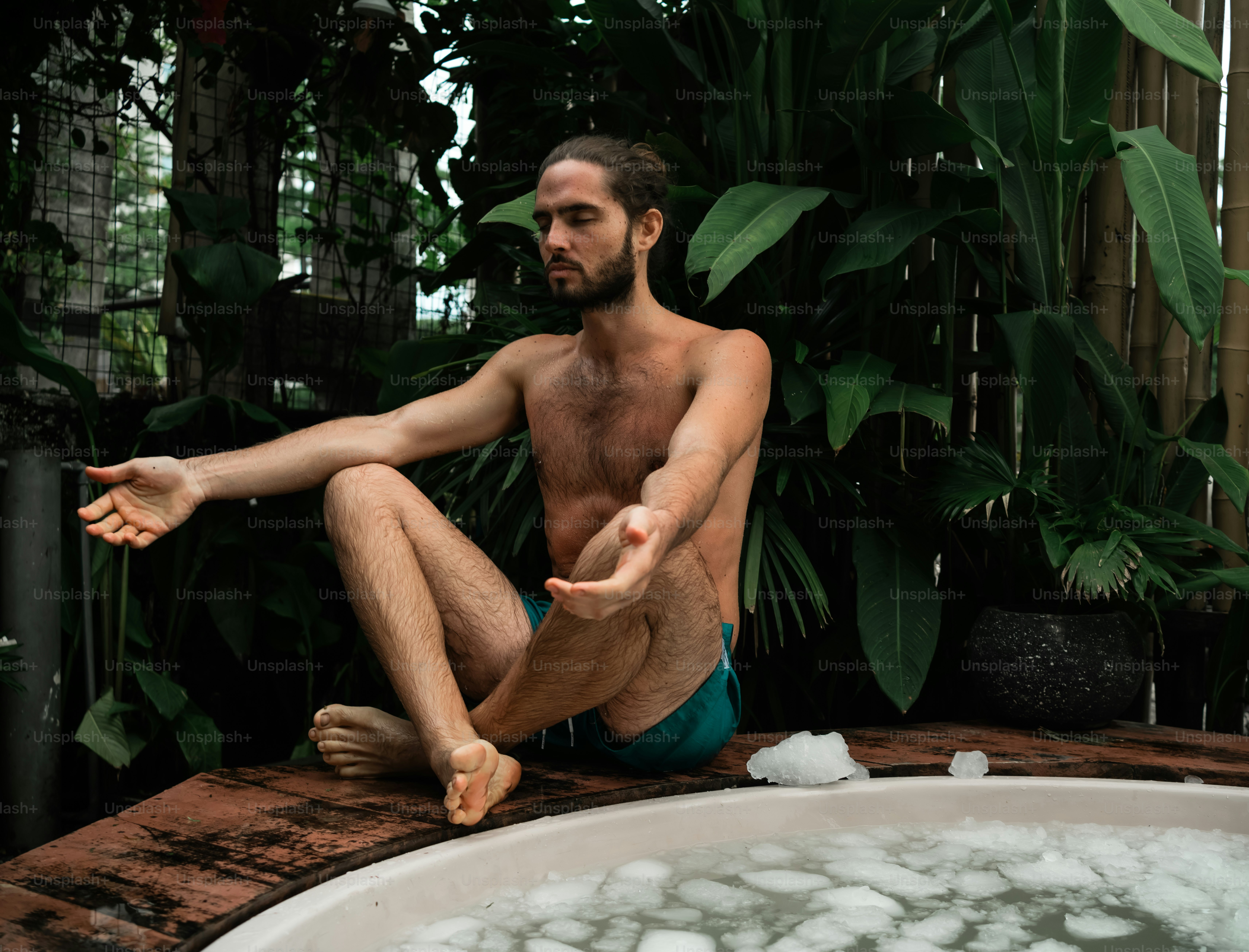 a man sitting in a bathtub full of ice