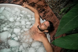 a man is taking a bath in a large tub