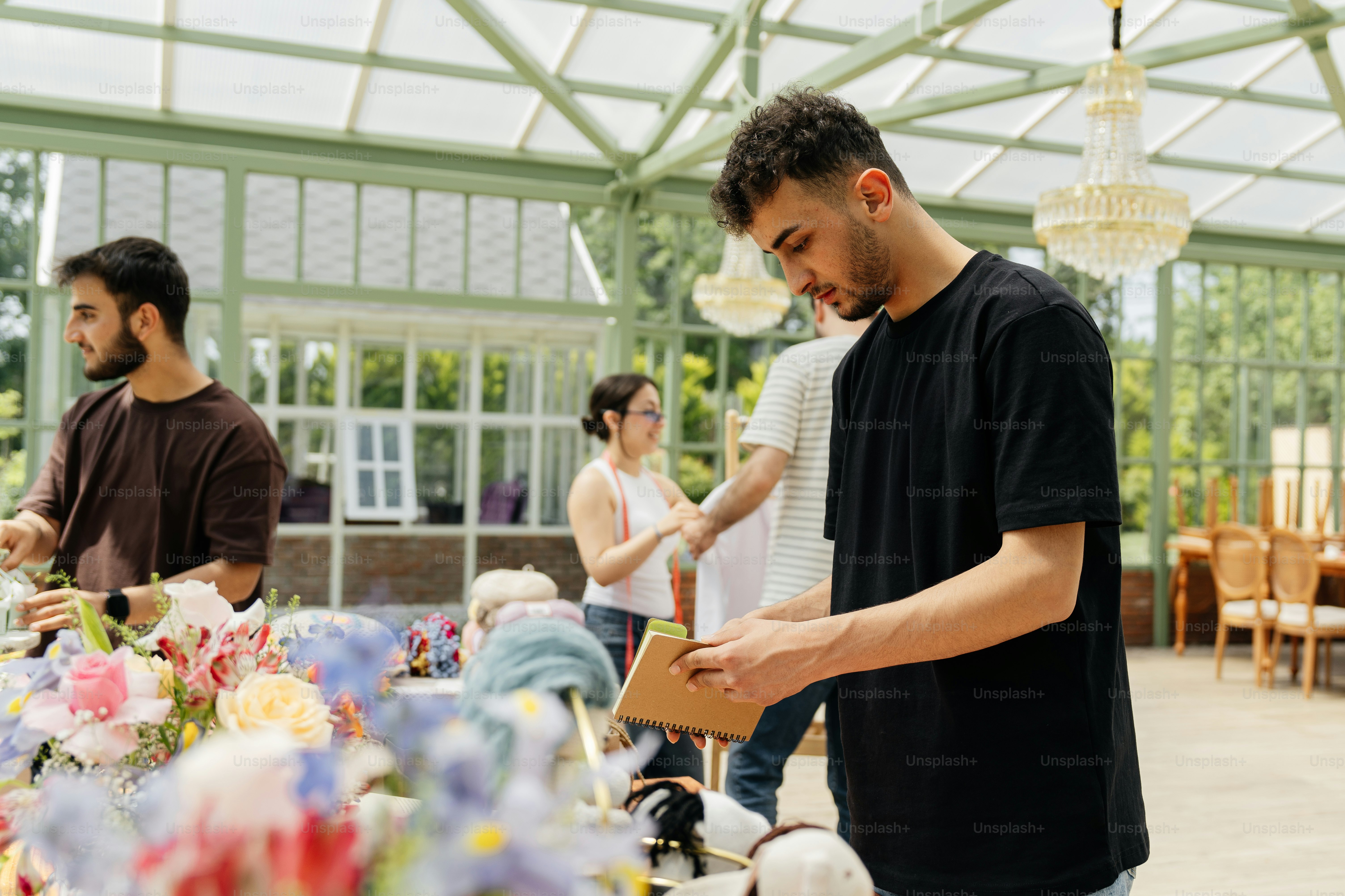 a group of people standing around a table covered in flowers