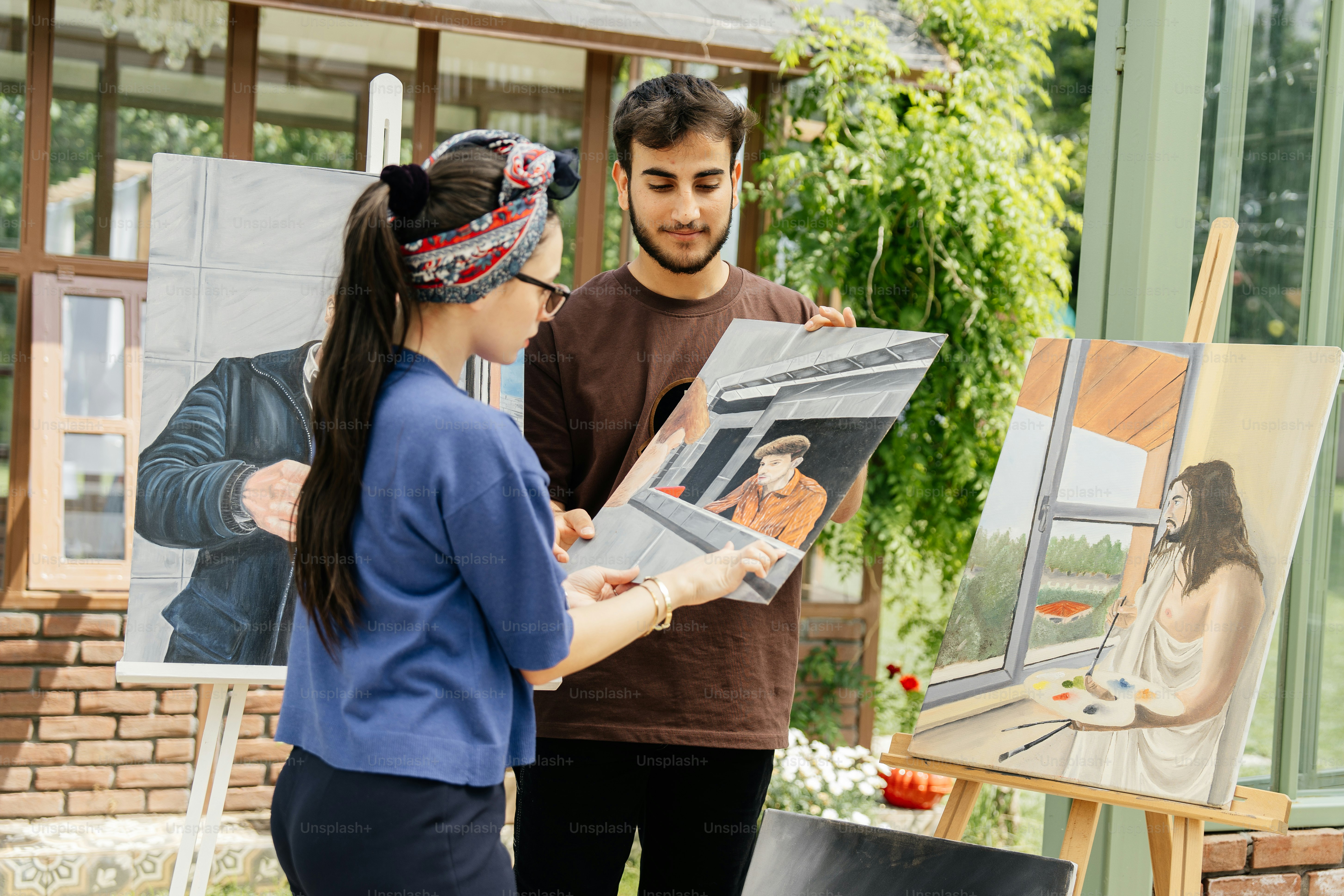 a man and a woman looking at a painting