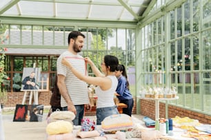 a man helping a woman put on a tie