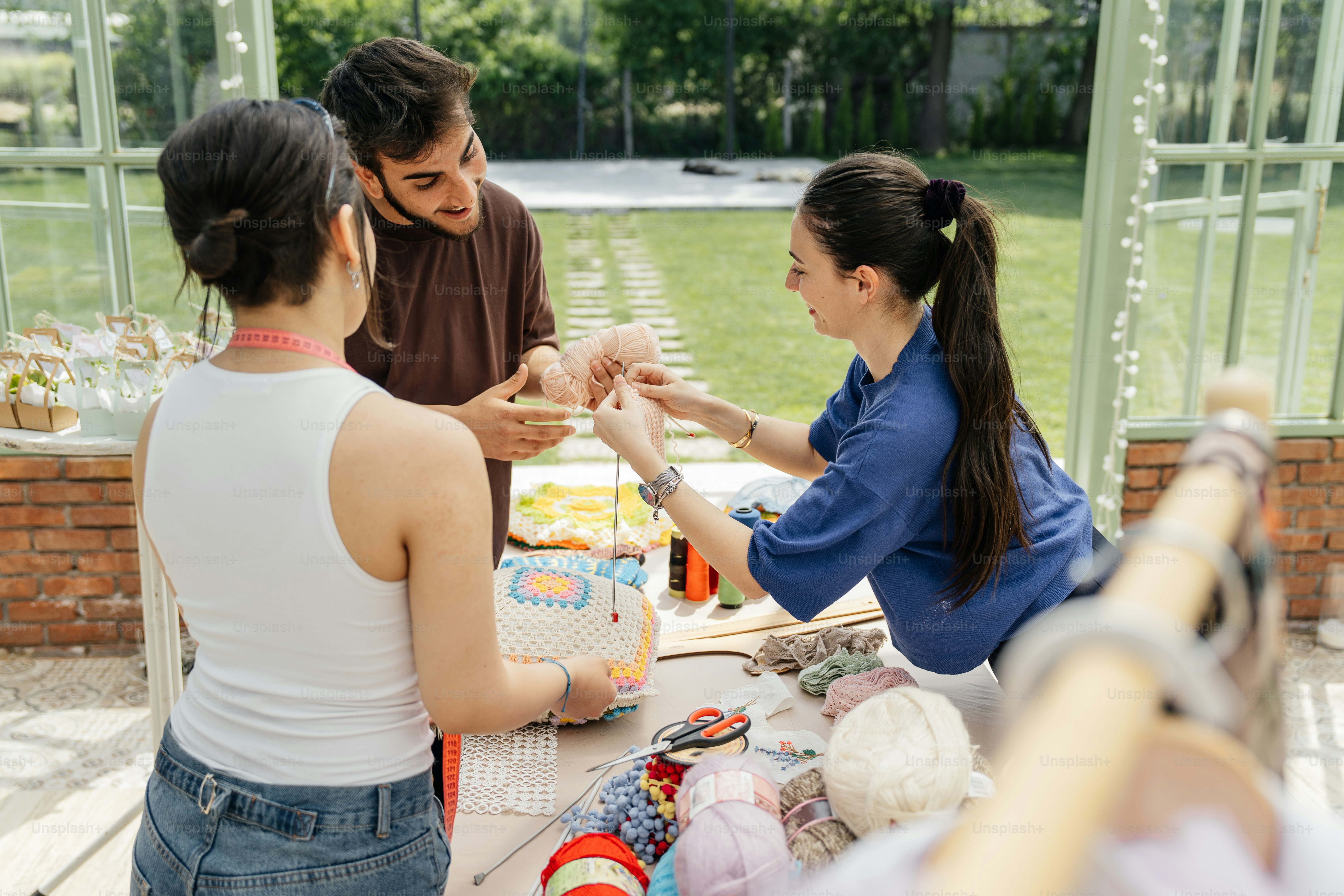 a group of people standing around a table