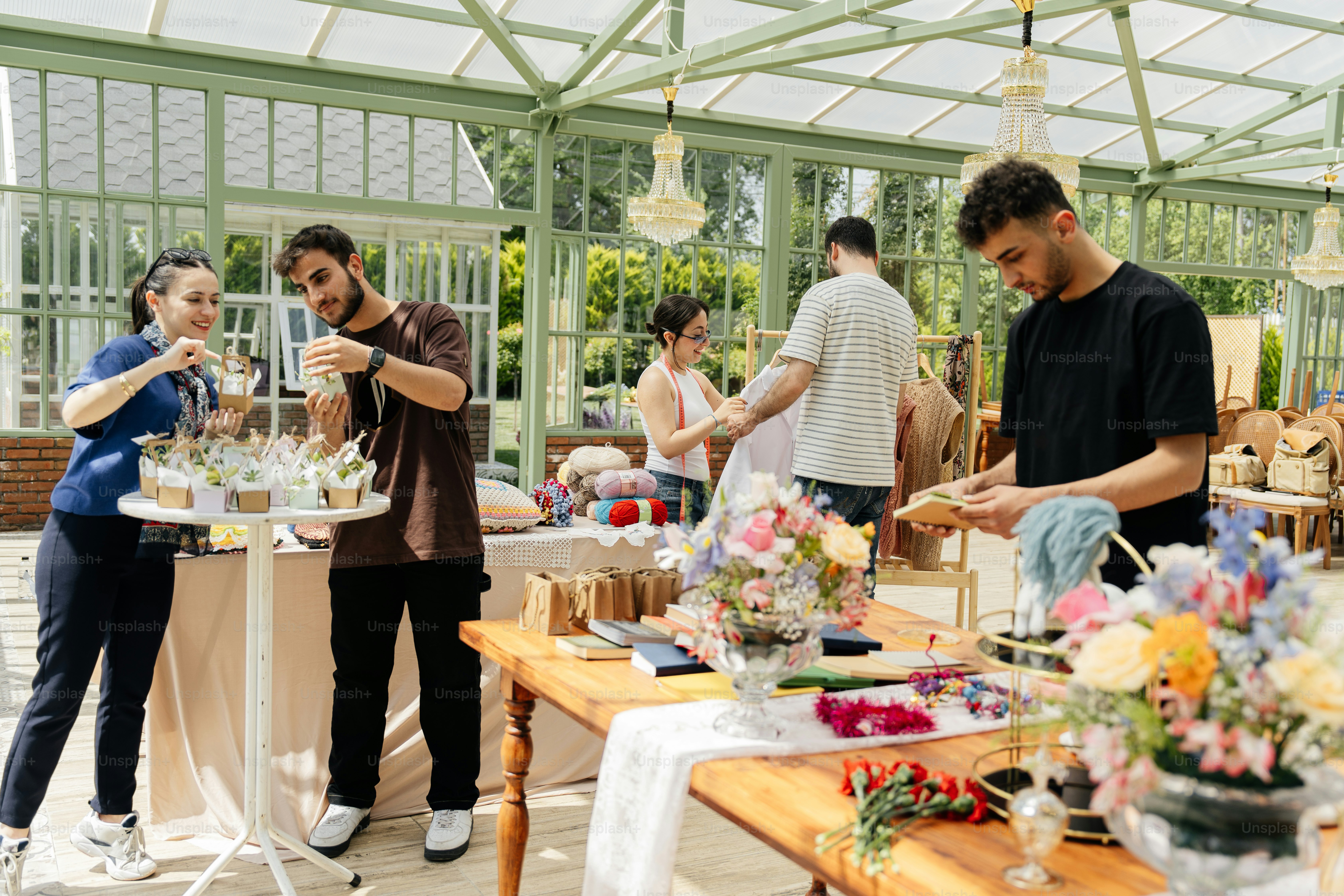 A group of people standing around a table photo – Market Image on Unsplash