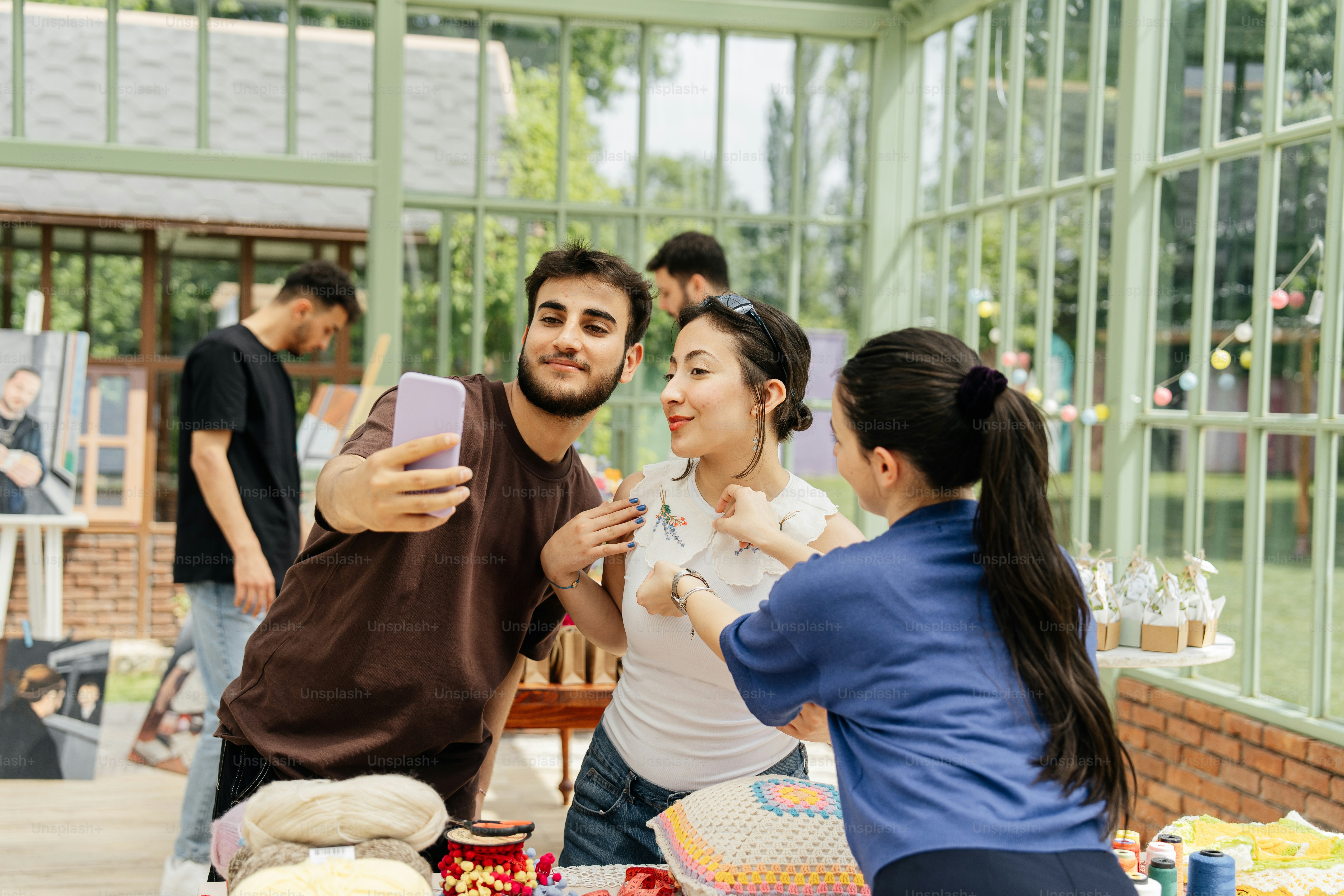 a group of people standing around a table