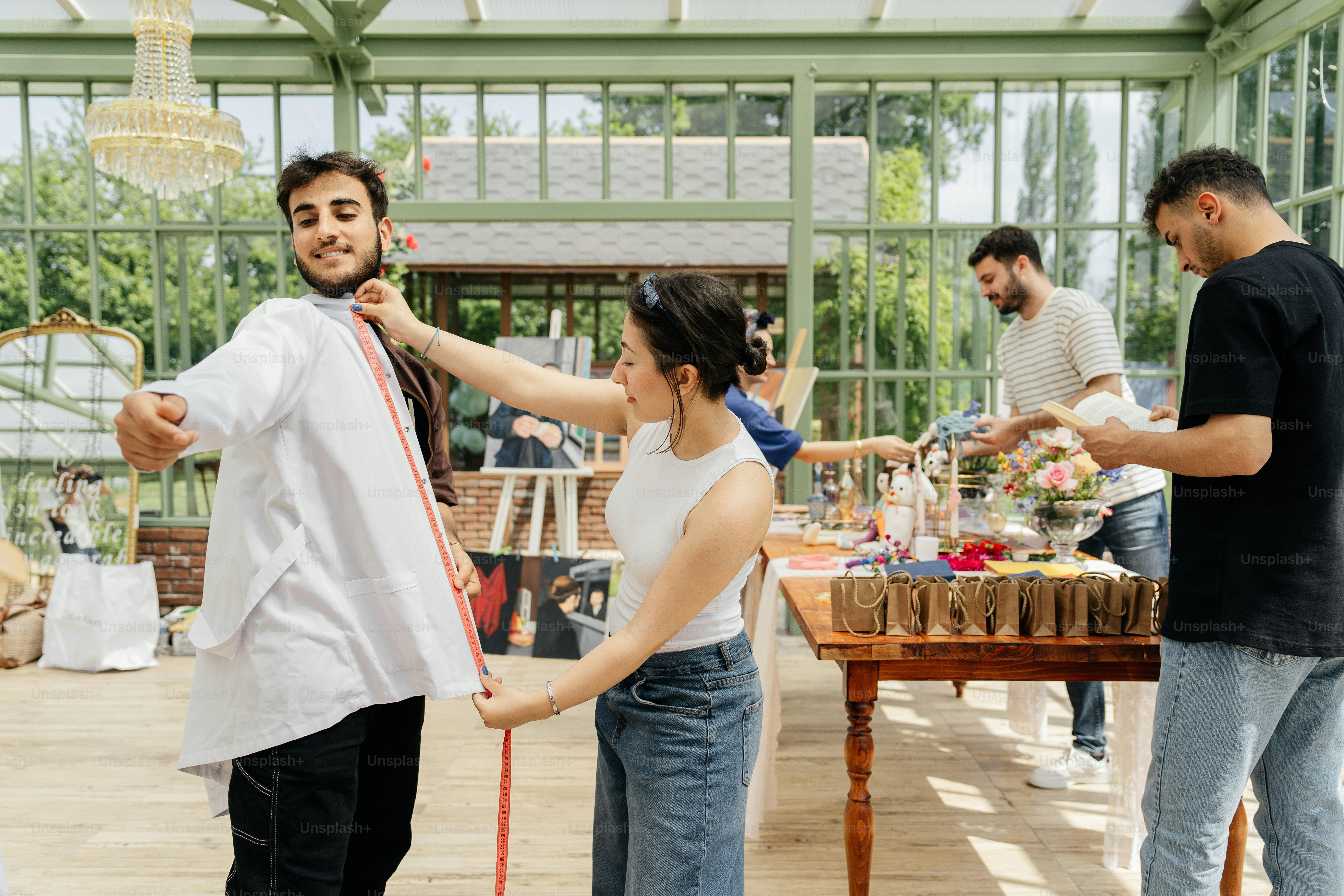 A group of people standing around a table photo – Market Image on Unsplash