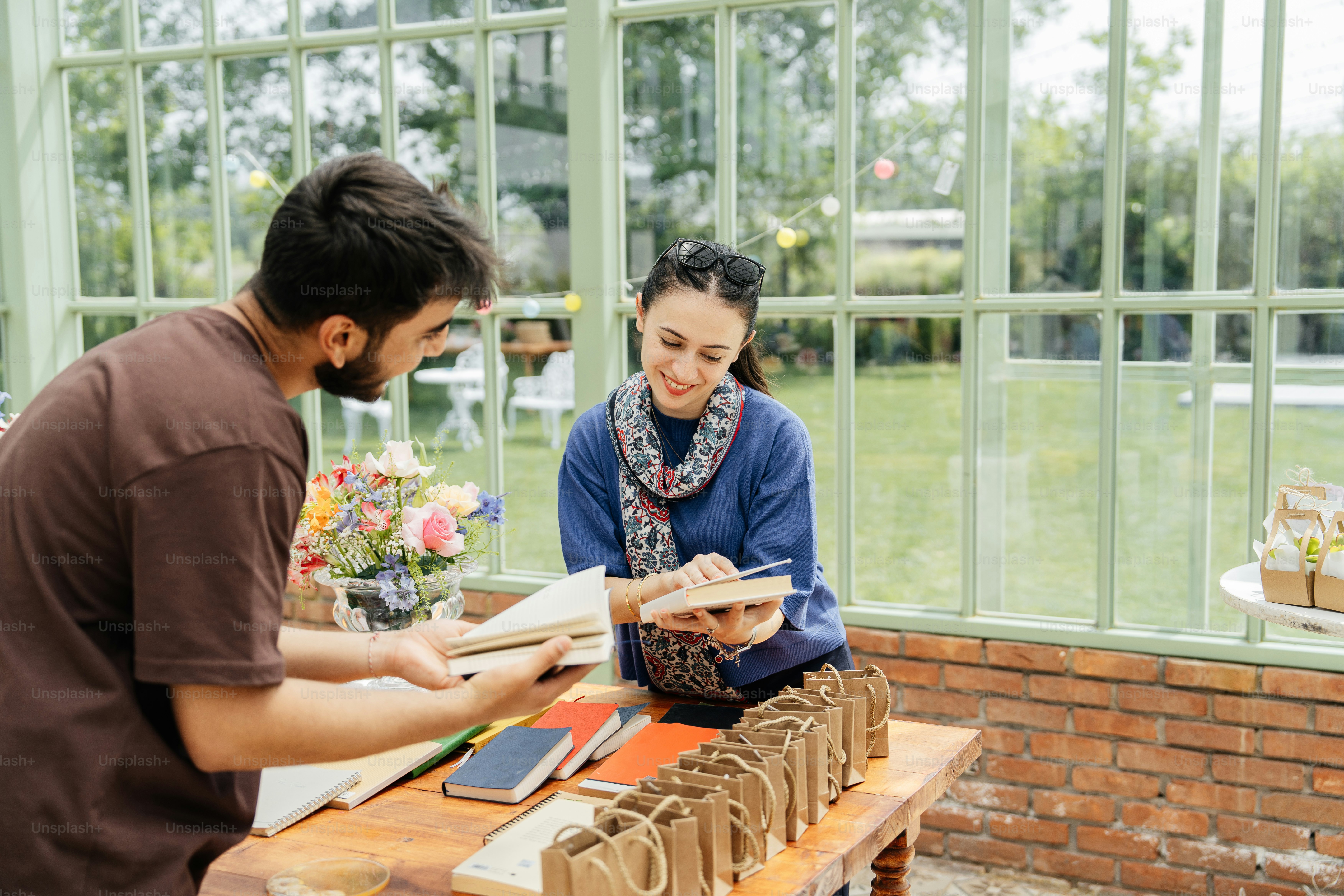 a man and a woman looking at a book