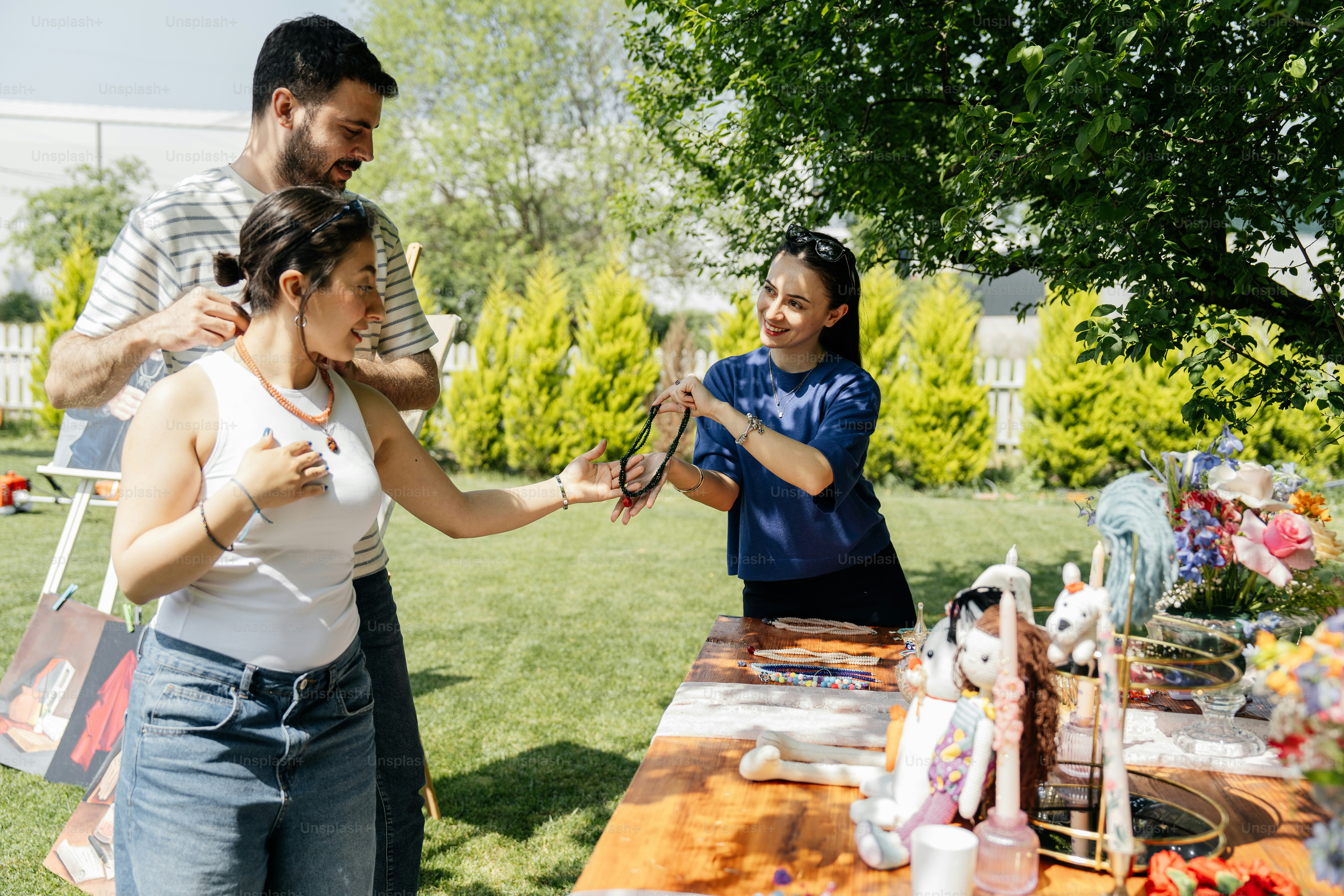 A group of people standing around a table photo – Market Image on Unsplash