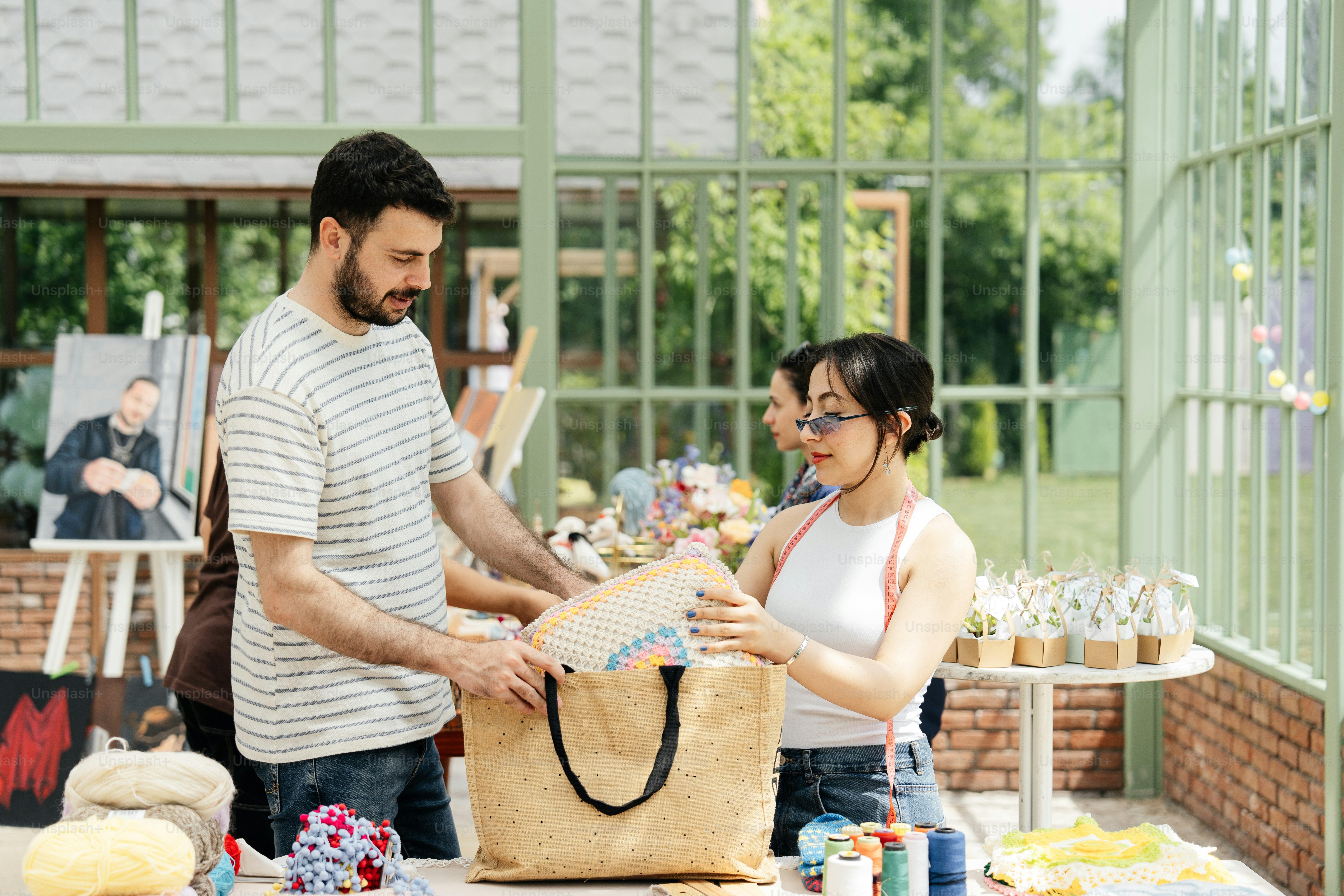 a man and a woman standing next to a bag