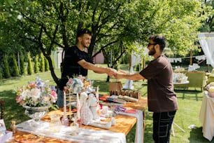 a couple of men shaking hands over a table