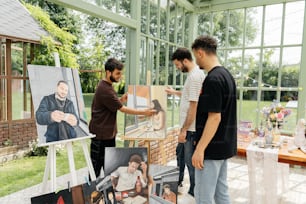 a group of men standing around a table with pictures on it