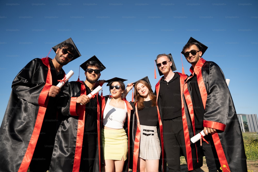 a group of people in graduation gowns posing for a picture