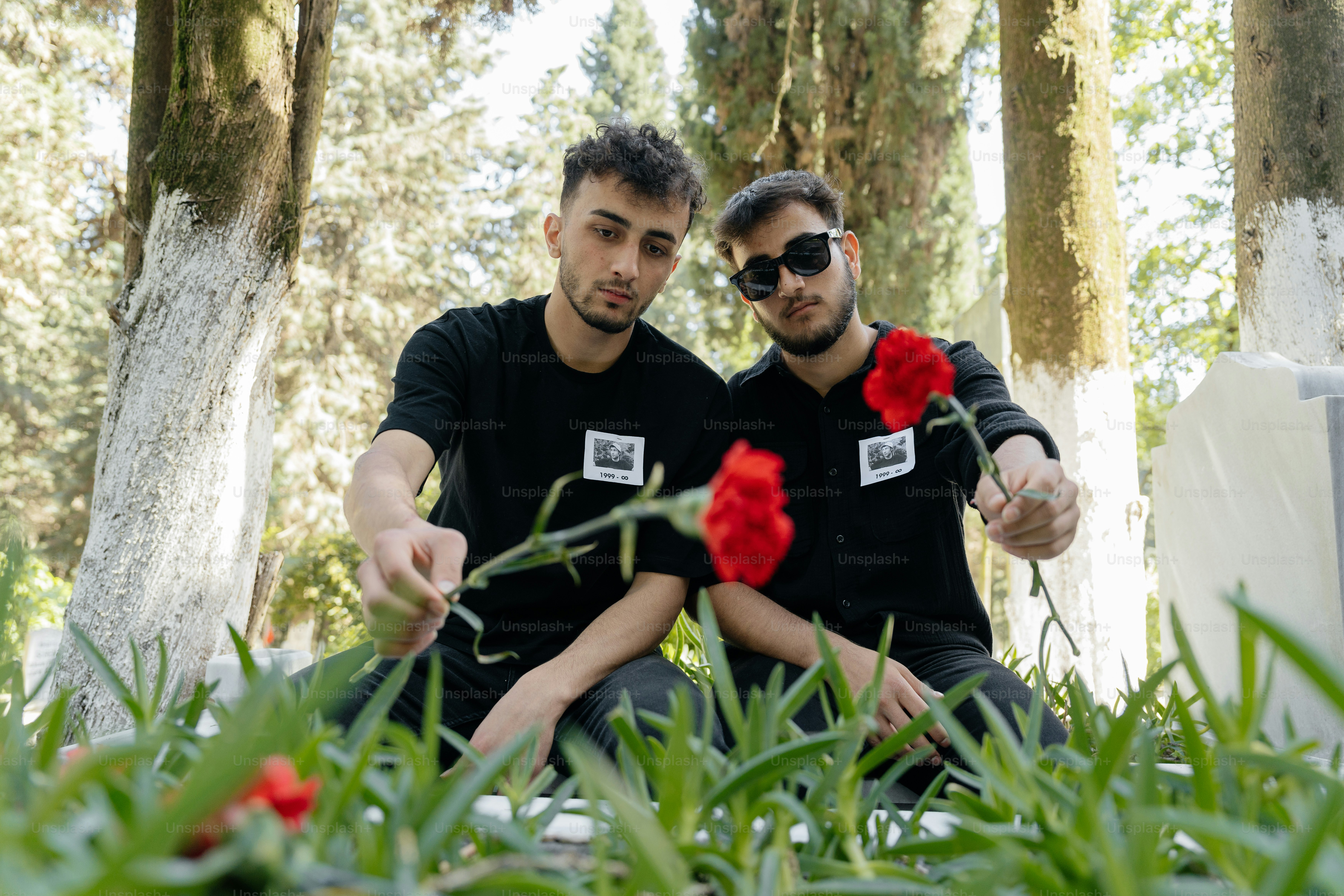 a couple of men sitting next to each other